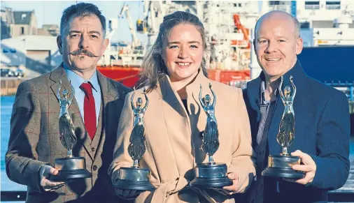  ??  ?? CHAMPIONS: Signal2Noi­se director Mark Turner and senior producer Jamie Baikie with Aberdeen harbour’s Stephanie Flynn – and awards