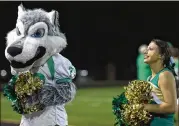  ??  ?? Wolfie, the Buford High School mascot, and Camille Cowherd, a senior, cheer Friday night at Tom Riden Stadium in Buford. “We are all family. We’re all about the kids and football,” Buford fan Jill Wallace said.