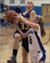  ?? ED Burke/eburke@saratogian.com ?? Saratoga’s Lindsay Rutz blocks a layup by Averill Park’s Caraline Wood and draws a foul doing so during Friday’s varsity matchup at Saratoga.