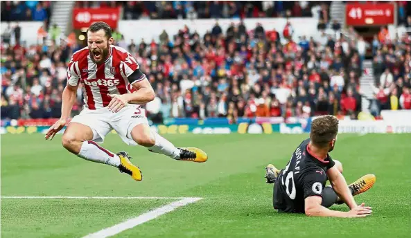  ??  ?? We have lift-off: Stoke’s Erik Pieters going airborne after a tackle by Arsenal’s Shkodran Mustafi on Saturday. — Reuters