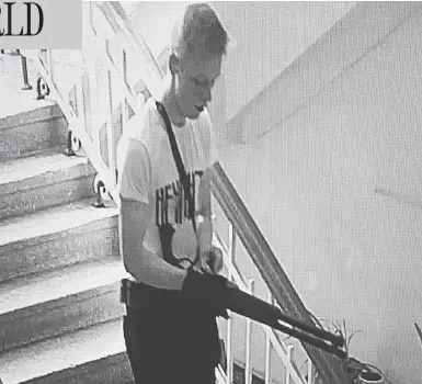  ?? CCTV FOOTAGE ?? A CCTV image appears to show student Vladislav Roslyakov, 18, stalking the halls of Kerch Polytechni­c College.