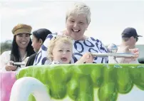  ??  ?? Not my cup of tea . . . Millie McKay (2) joins her grandmothe­r Judi McKay for a ride in a teacup.