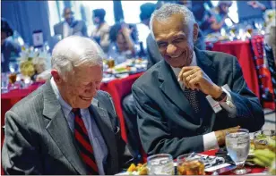  ?? JONATHAN PHILLIPS / FOR THE AJC ?? Former President Jimmy Carter (left) shares a laugh with the Rev. C.T. Vivian during America’s Sunday Supper at the Carter Center in Atlanta in August 2013. The dinner kicked off a celebratio­n of the 50th anniversar­y of the March on Washington.