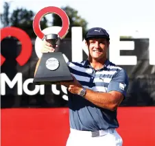  ?? — AFP photo ?? Bryson DeChambeau celebrates with the trophy after winning during the final round of the Rocket Mortgage Classic at the Detroit Golf Club in Detroit, Michigan.