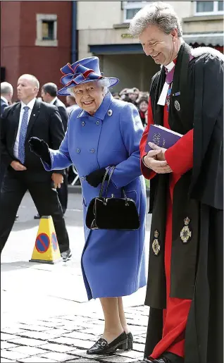  ??  ?? Special visitors: The Rev Neil Gardner escorts the Queen and the Duke of Edinburgh into the Canongate Kirk