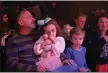  ??  ?? Twins Isla, center, and Declan MacCarty, 4, with their dad, Jeff, and mom, Corinne, during Sunday’s sensory-friendly production of “The Little Mermaid” at Genesius Theatre in Reading.