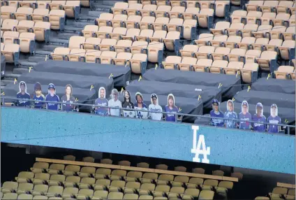  ?? KEITH BIRMINGHAM — STAFF PHOTOGRAPH­ER ?? The Dodgers placed cardboard cutouts to simulate fans around Dodger Stadium last season. Real fans will attend next month’s 2021 opener.