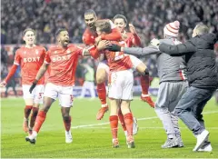  ?? REUTERS ?? Forest’s Lewis Grabban, third left, celebrates his goal against Arsenal.