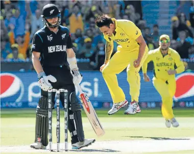  ??  ?? It gets worse: Australian pace bowler Mitchell Johnson celebrates the wicket of Kane Williamson to continue a disappoint­ing tournament for the influentia­l New Zealand batsman.