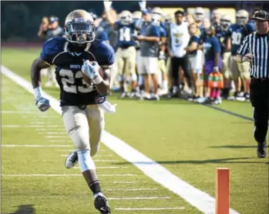  ?? PETE BANNAN — DIGITAL FIRST MEDIA ?? Brandon Frazier scores one of his three touchdowns for Rustin in Friday’s 33-6 win over Oxford.