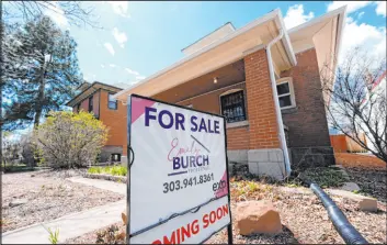  ?? David Zalubowski The Associated Press ?? A for sale sign stands outside a home April 3 in Denver. Holding out for more attractive mortgage rates later this year could give homebuyers some financial breathing room.