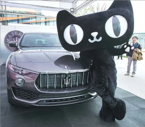  ?? XU KANGPING / FOR CHINA DAILY ?? A Tmall mascot poses with a Maserati SUV Levante 350HP in Hangzhou, Zhejiang province, after the luxury carmaker sold its first 100 models on the Alibaba online platform. Starting at 999,800 yuan, Maserati sold all 100 cars in 15 minutes last year.