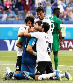  ?? — Reuters photo ?? El-Hadary celebrates with team mates after saving a penalty kick.