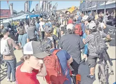  ?? ?? Lucas Ferry from Santa Clara, is last in line to the dart-throwing competitio­n at one of many vendors at the Sea Otter Classic cycling festival’s exhibit area.