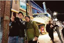  ?? Chris Pizzello/Invision ?? Kenneth Baran and Clement Chen pose for a selfie outside the Egyptian Theatre before the start of the Sundance Film Festival.