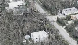  ??  ?? The Sunrise Motel sits under water in East Naples, Florida, while homes are surrounded by battered trees. Right, holiday-makers leave the Caribbean island of St Martin