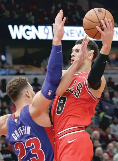  ?? NAM Y. HUH/AP ?? Zach LaVine takes it to the hoop against Pistons forward Blake Griffin in the second half of the Bulls’ home opener.