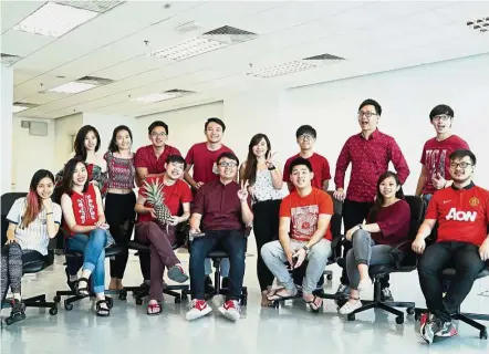  ??  ?? Building a media group: (front row) Tan (middle), Yap (third from right) and Choong (right) are enthusiast­ic about growing GGTV Production­s with their staff and interns.
