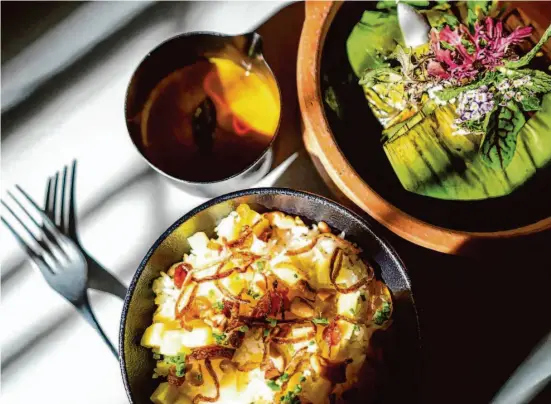  ?? Photos Adam Pardee/Special to The Chronicle ?? Banana leaf-wrapped black cod pollichath­u is served with a coconut-sweet side broth and ghee rice.