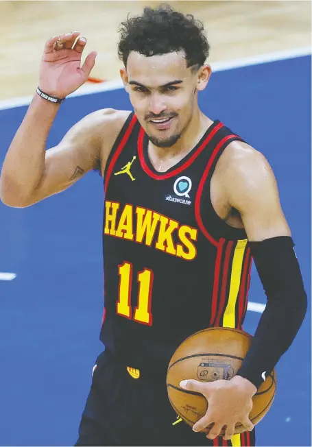  ?? TIM NWACHUKWU/GETTY IMAGES ?? Trae Young of the Atlanta Hawks, a cool new star on a cool young team, celebrates after defeating the Philadelph­ia 76ers during Game 7 of the Eastern Conference semifinals. Young has been central to the Hawks' rebuild, which started with a teardown just six years ago.