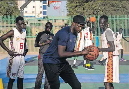  ?? Photo: Akuot CHOL/AFP ?? Hope: Luol Deng (centre) trains young players at the Manute Bol basketball court, built by the two-time Allstar NBA player’s foundation in South Sudan’s capital Juba.