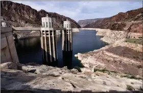  ?? RICHARD VOGEL — THE ASSOCIATED PRESS ?? This photo shows the water level of the Colorado River, as seen from the Hoover Dam, Ariz. For the seven states that rely on the Colorado River that carries snowmelt from the Rocky Mountains to the Gulf of California, that means a future with increasing­ly less water for farms and cities although climate scientists say it’s hard to predict how much less.