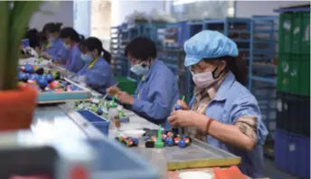  ??  ?? Workers make toys at a poverty-relief workshop in Zhangjiaji­e, Hunan Province in central China, on May 27