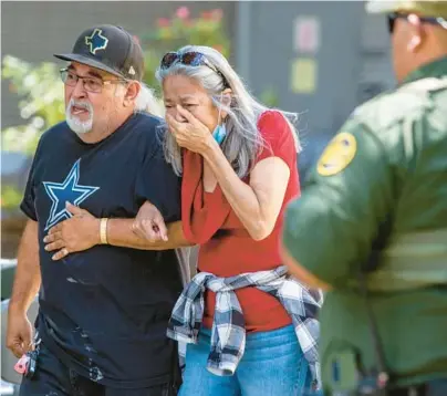  ?? WILLIAM LUTHER/SAN ANTONIO EXPRESS-NEWS ?? A woman cries Tuesday as she leaves the Civic Center in Uvalde, Texas.