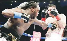  ??  ?? Bermane Stiverne (left), hits Chris Arreola during their rematch for the WBC heavyweigh­t boxing title in Los Angeles, May 10. Stiverne won the title. (AP)