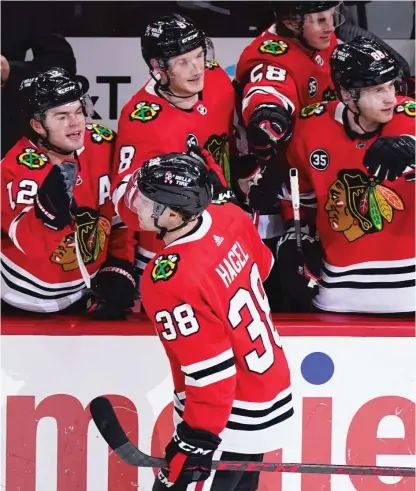  ?? AP ?? Blackhawks wing Brandon Hagel celebrates with teammates after scoring in the second period Saturday against the Ducks.