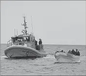  ?? United States Coast Guard ?? MEMBERS of the Coast Guard rescue people from a disabled boat Saturday off the Redondo Beach coast.