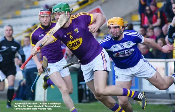  ??  ?? Joint captain Matthew O’Hanlon is challenged by Charles Dwyer (Laois) in Sunday’s hardearned win in Innovate Wexford Park.