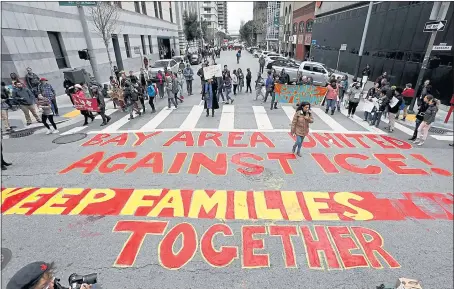  ?? KARL MONDON — STAFF PHOTOGRAPH­ER ?? Protesters paint a message on the street in front of the Immigratio­n and Customs Enforcemen­t office in San Francisco on Wednesday.