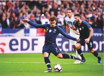  ?? AFP ?? France forward Antoine Griezmann scores their second goal from a penalty kick against Germany during the Uefa Nations League match in Saint-Denis, near Paris, on Tuesday.