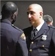  ?? CLEVELAND.COM ?? Cleveland police officer Ismail Quran receives the “Officer of the Year” award during a ceremony in 2021. His social media posts are now the subject of an internal investigat­ion, officials said.