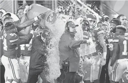  ?? GEOFF BURKE/ USA TODAY SPORTS ?? Chiefs head coach Andy Reid is dunked with Gatorade by his players Jordan Lucas ( 24) and Cameron Erving ( 75) in the fourth quarter of Super Bowl LIV.