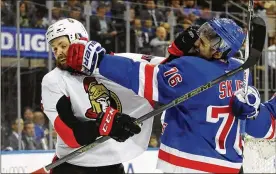  ?? GETTY IMAGES ?? Ottawa’s Zack Smith and New York’s Brady Skjei battle during the first period of the Rangers’ 4-1 win in Thursday night’s Game 4 at Madison Square Garden.