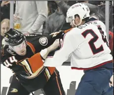  ?? Associated Press ?? Ducks left wing Ross Johnston (44) fights with Columbus Blue Jackets right wing Mathieu Olivier (24) during the second period, Wednesday, in Anaheim.