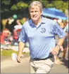  ?? Brian A. Pounds / Hearst Connecticu­t Media ?? Republican candidate for governor Bob Stefanowsk­i runs back and forth shaking hands during the Newtown Labor Day Parade on Main Street in Newtown last Monday.