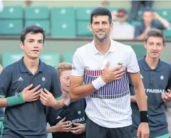  ?? EPA ?? Novak Djokovic jokes with ball children after his victory on Sunday.