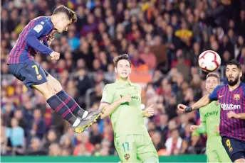  ?? — AFP photo ?? Philippe Coutinho (left) heads the ball during the Spanish La Liga match between FC Barcelona and Levante UD at the Camp Nou stadium in Barcelona in this April 27 file photo.