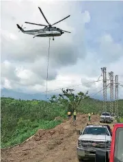  ?? [PHOTOS PROVIDED BY MAMMOTH ENERGY SERVICES, INC.] ?? A helicopter supports a line being attached to a transmissi­on pole in Puerto Rico recently. Mammoth Energy Services announced Wednesday it had acquired companies that provide that type of service.