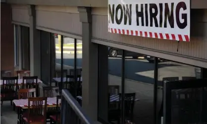  ?? ?? A ‘now hiring’ sign is seen outside a restaurant in Arlington, Virginia. Photograph: Olivier Douliery/AFP/Getty Images