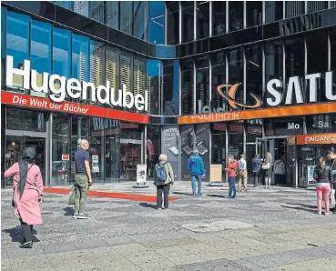  ?? /Bloomberg ?? Restarting:
Customers form a social distancing queue to enter a Saturn electronic goods store, operated by Ceconomy, as it reopens for business in Berlin, Germany, on April 22. Germany began easing lockdown rules this week.