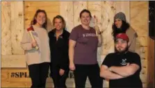  ??  ?? A group of women who participat­ed in a special victress-themed yoga and axe throwing night pose for a photo along with their axe throwing instructor Shane Dugan.