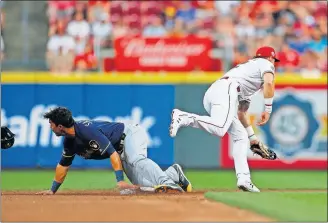  ?? [GARY LANDERS/THE ASSOCIATED PRESS] ?? The Brewers’ Tyler Saladino steals second as the throw gets away from the Reds’ Derek Dietrich in the fifth inning.