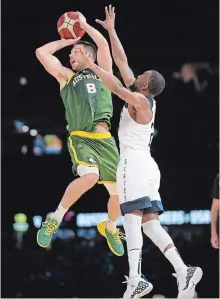  ?? ANDY BROWNBILL THE ASSOCIATED PRESS ?? Matthew Dellavedov­a of Australia tries a shot in an exhibition basketball game against the U.S. in Melbourne on Thursday. The U.S. won, 102-86.