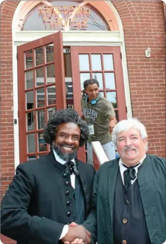  ??  ?? During a break in filming at the Newtown Theatre, Actor Keith David, who portrays abolitioni­st Frederick Douglass, talks with Newtown Borough Mayor Dennis O’Brien. The mayor has a small part in “The North Star.” In the background is writer/director...