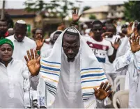  ?? (Marco Longari/AFP/Getty Images) ?? IGBO JEWS celebrate Shabbat in 2017. Three dual-Israeli filmmakers have become caught up in a separatist movement led by a Jewish activist.