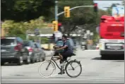  ?? PHOTO BY THOMAS R. CORDOVA ?? Long Beach is planning a bicycle corridor for Orange Avenue. Here, a cyclist rides along Atlantic Avenue in 2016.